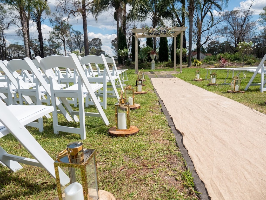 Medium Gold Lanterns with LED Pillar Candles on Wooden Slices